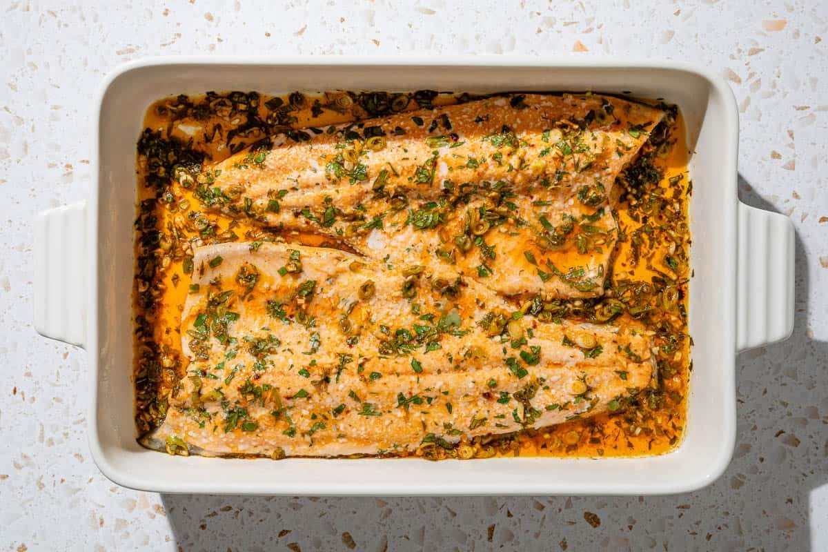 To baked trout fillets in a baking dish.
