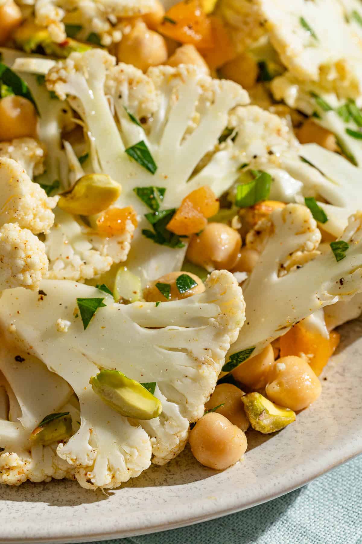 A close up photo of a shaved cauliflower salad in a serving bowl.