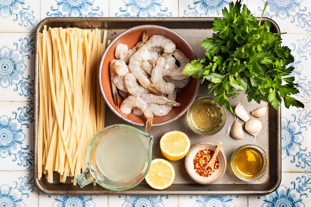 Ingredients for shrimp linguine including large shrimp, linguine olive oil, garlic, salt, crushed red pepper, white wine, clam juice, lemon, and parsley.