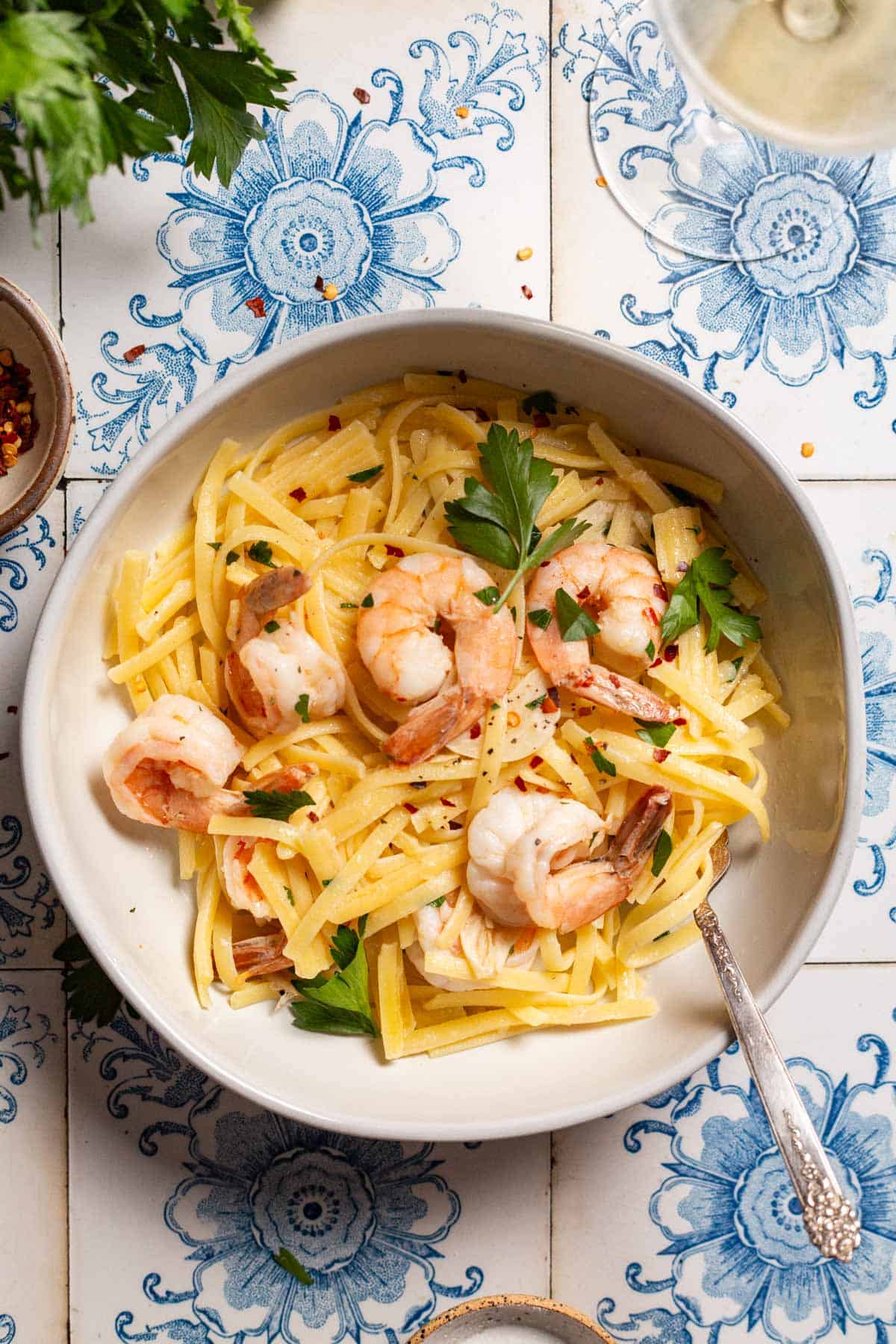 An overhead photo of srimp linguine in a bowl with a fork.