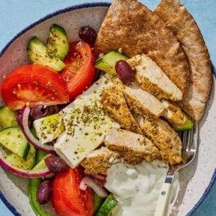 An overhead photo of a gyro bowl with a fork.