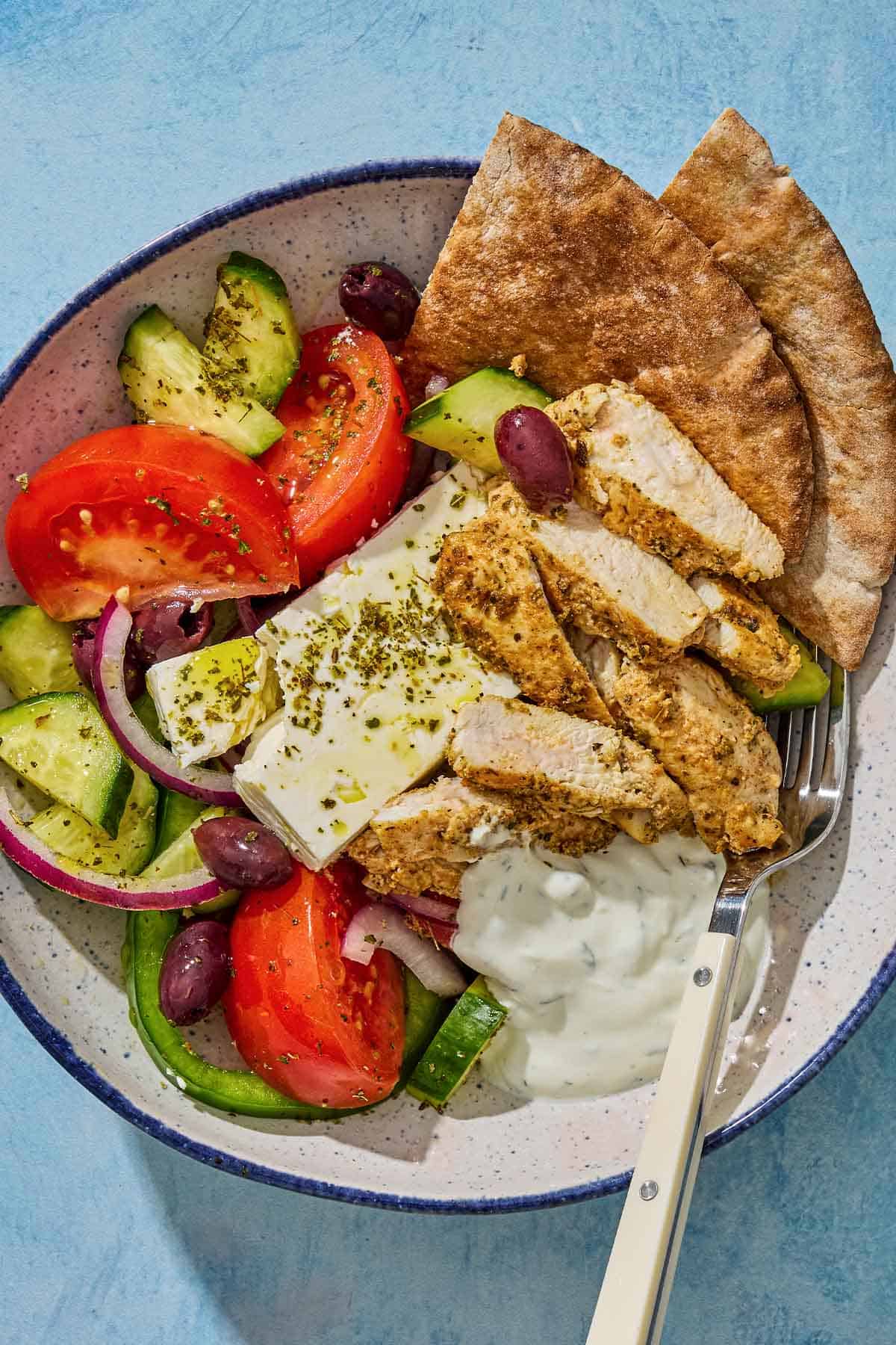 An overhead photo of a gyro bowl with a fork.