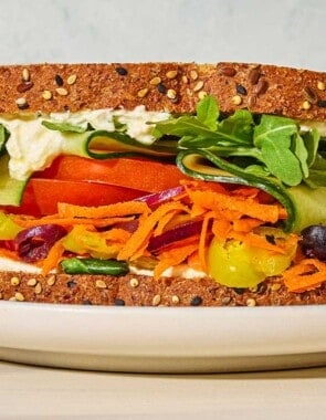 A close up of a veggie sandwich on a plate.
