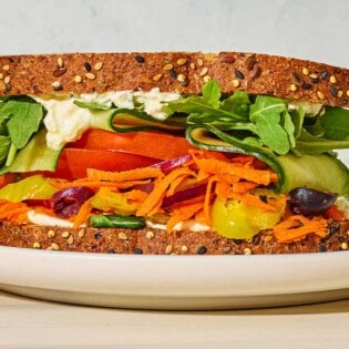A close up of a veggie sandwich on a plate.