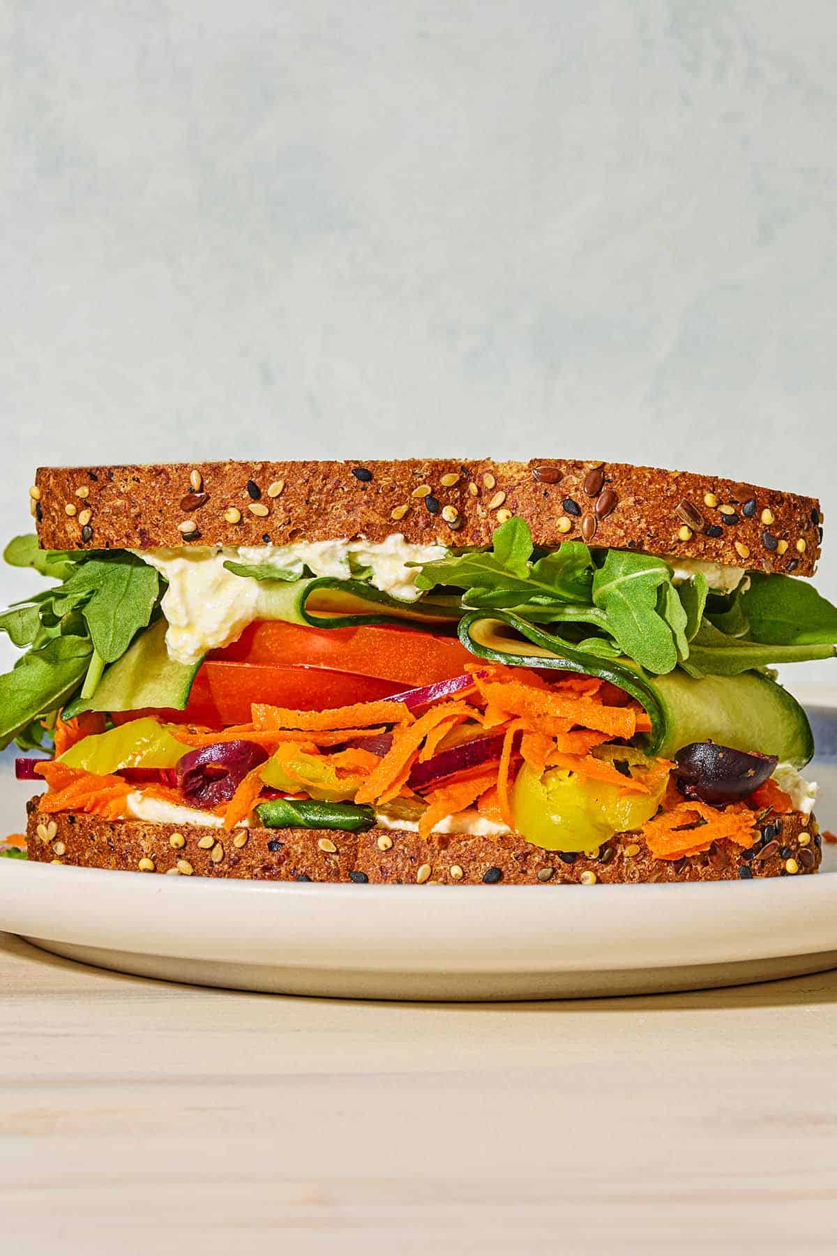 A close up of a veggie sandwich on a plate.