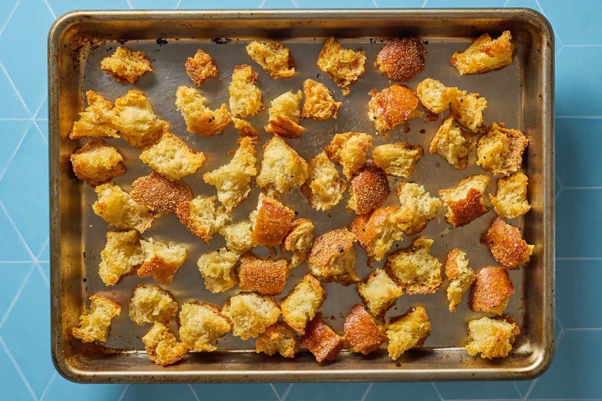 Croutons after they've toasted, showing their golden edges.