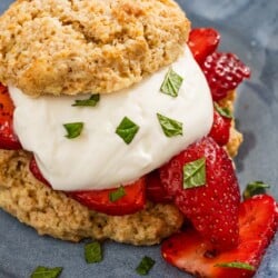 A close up of a strawberry shortcake on a plate.