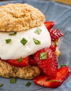 A close up of a strawberry shortcake on a plate.