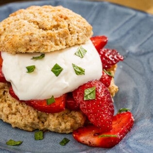 A close up of a strawberry shortcake on a plate.