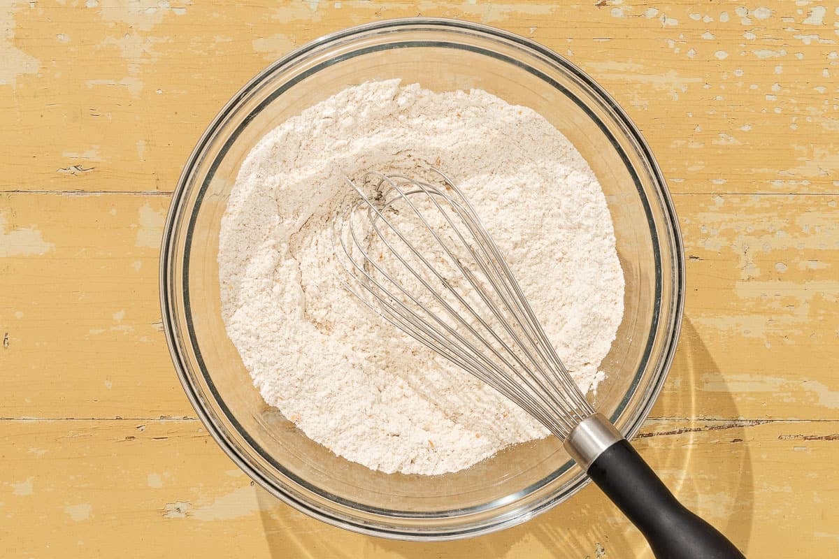 The dry ingredients for the shortcake dough in a bowl with a whisk.