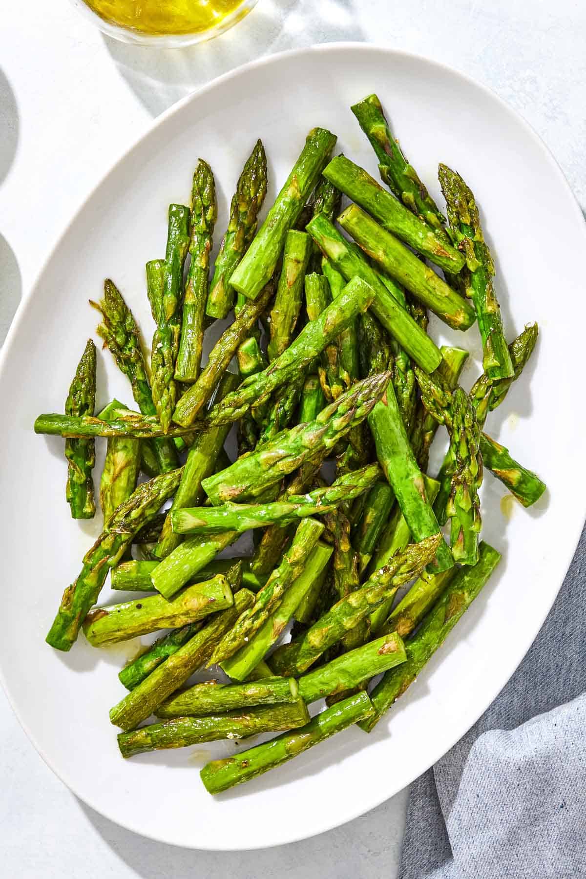 An overhead photo of sauteed asparagus on a serving platter.