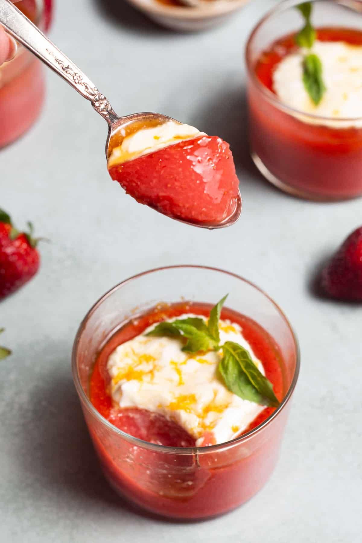 A spoonful of strawberry pudding, showing its gel-like texture and glossy finish.