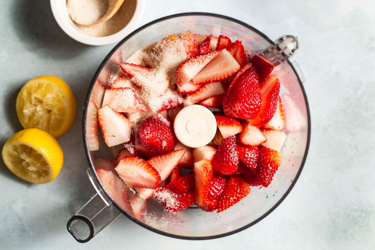 strawberries, sugar and lemon juice in a food processor before it's blended to make strawberry pudding.