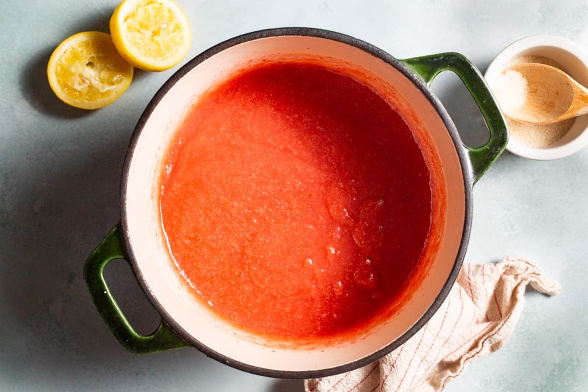 a saucepan with strawberry puree gently bubbling to make strawberry pudding.