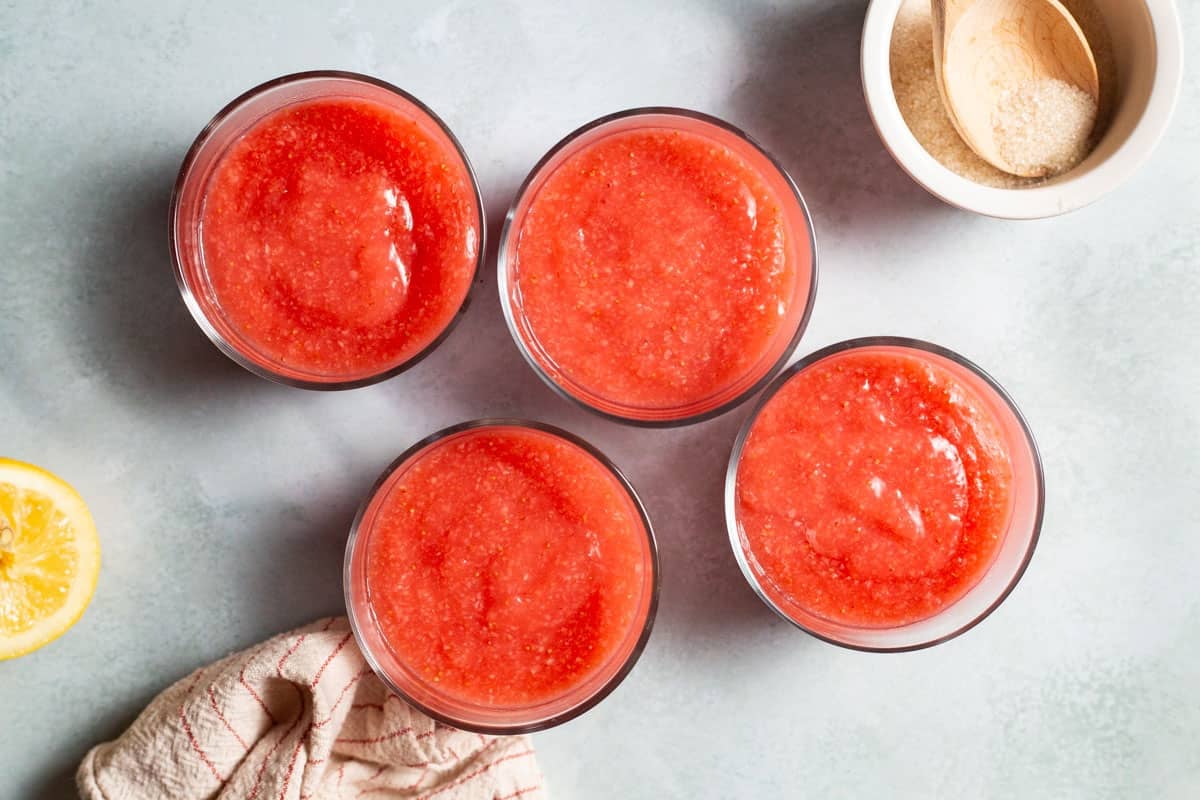 four glasses with strawberry pudding.