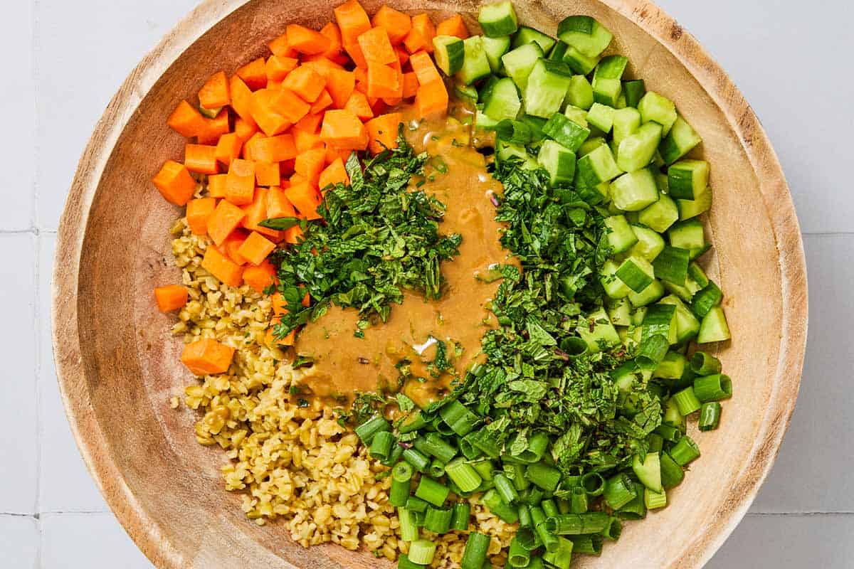 The ingredients for the herby freekeh salad in a bowl just before being mixed together.