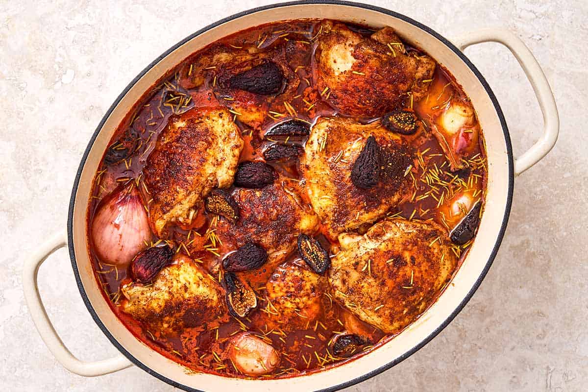 The ingredients fort the wine braised chicken thighs simmering in a large pot.