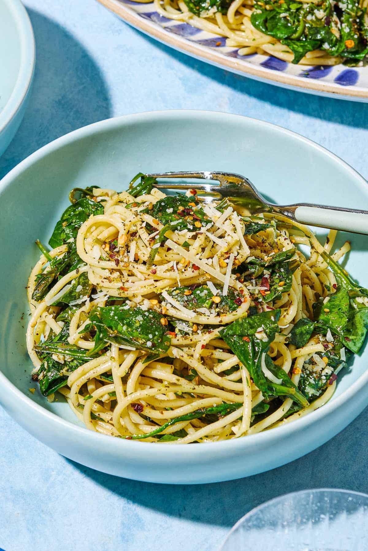 A serving of za'atar garlic spinach pasta in a bowl with a fork.