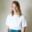 Headshot of Devin Fuller by photographer Aya Brackett. She's waring a white shirt and teal skirt and she has blond shoulder-length hair.