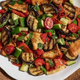 Grilled eggplant salad on a serving platter.