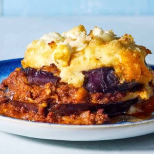 A close up of a serving of Greek Shepherd's Pie on a plate.