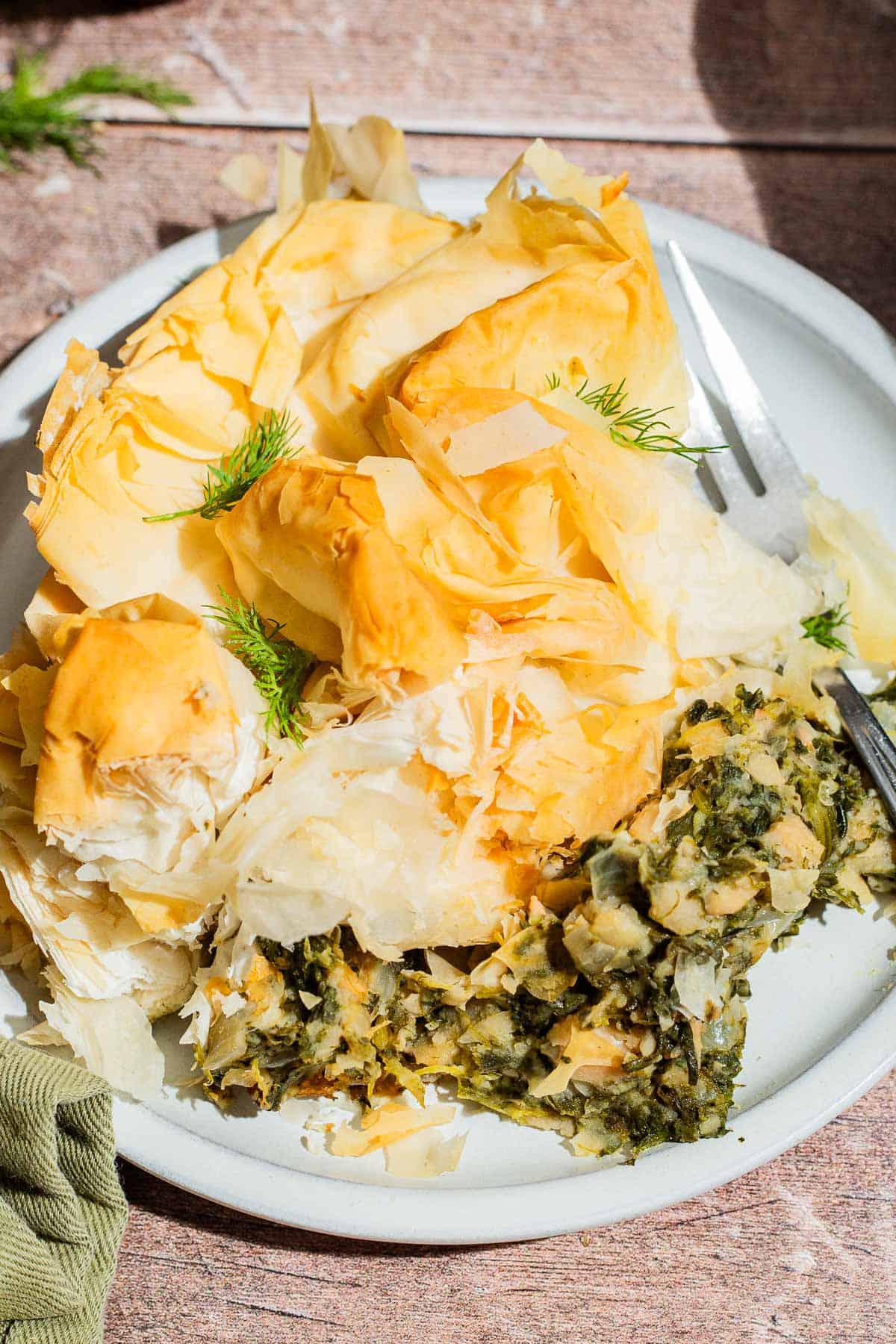 A close up of vegan skillet spanakopita on a plate with a fork.