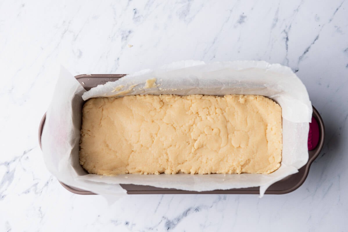 Cooled halva in a parchment lined loaf pan.