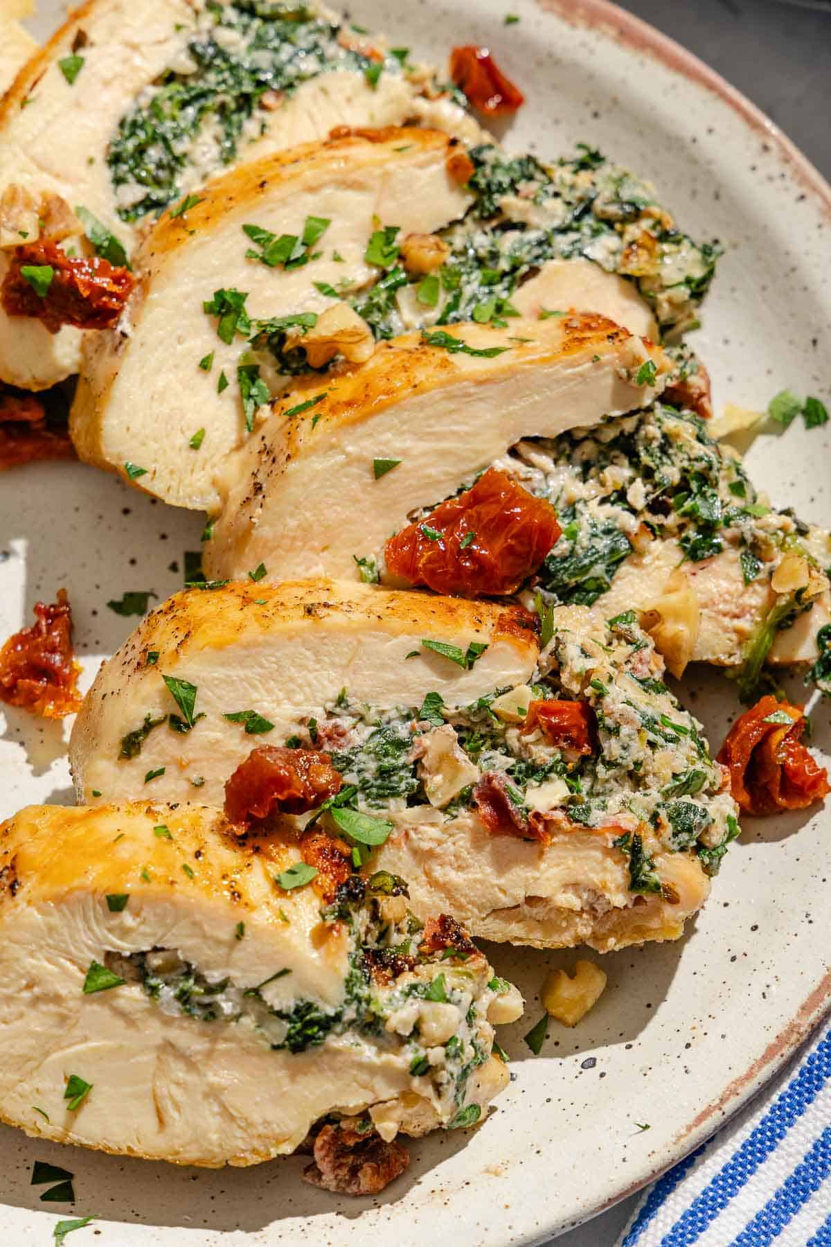 A sliced spinach stuffed chicken breast on a plate.
