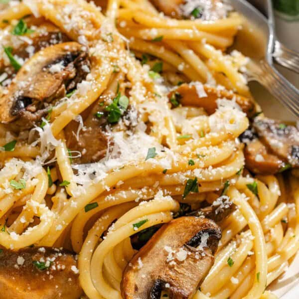 Vegetarian carbonara in a bowl with a fork and spoon.