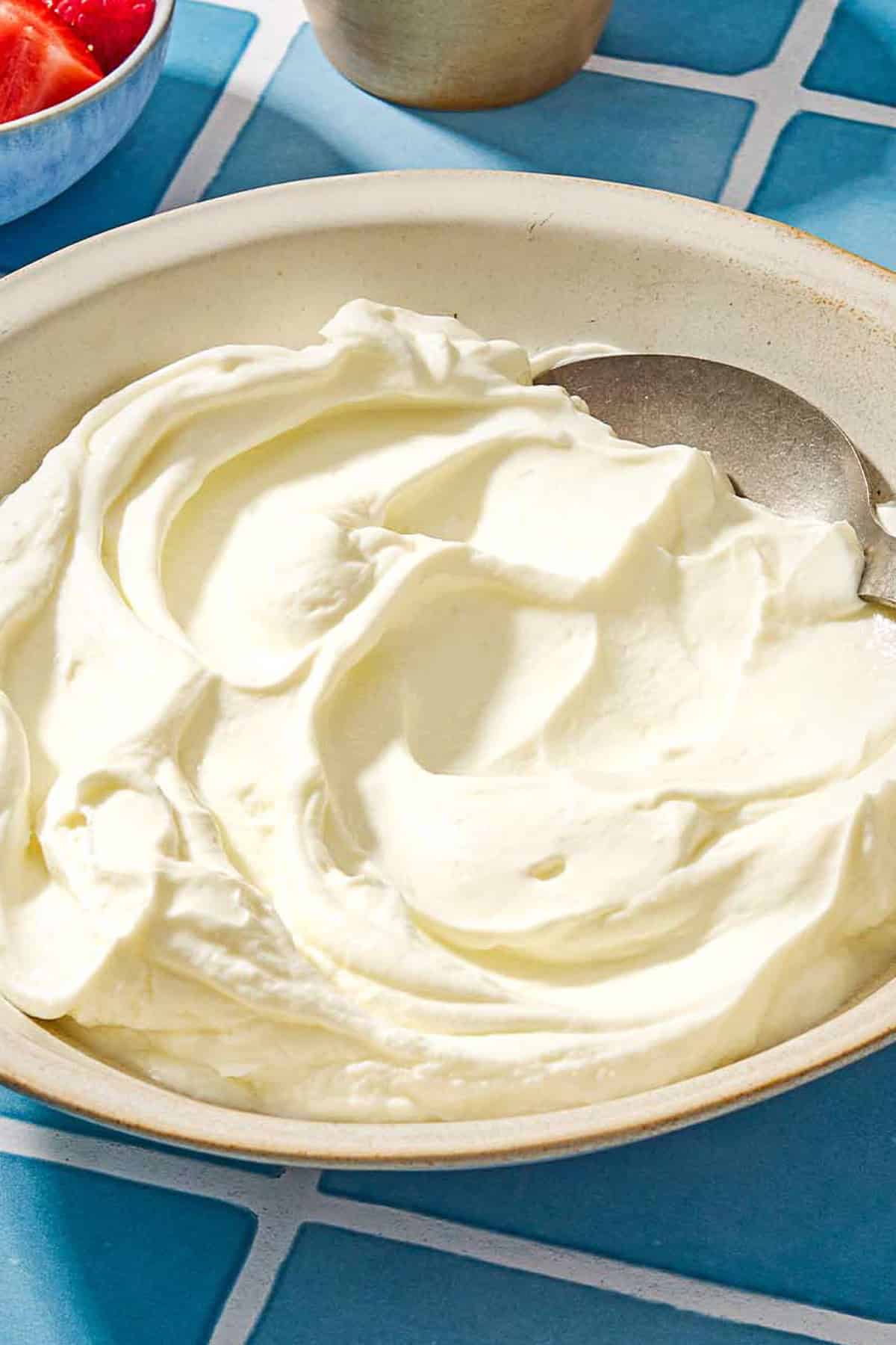 Homemade greek yogurt in a bowl with a spoon.