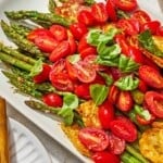 Roasted Asparagus Salad with Fried Halloumi and Fresh Tomatoes on a serving platter.