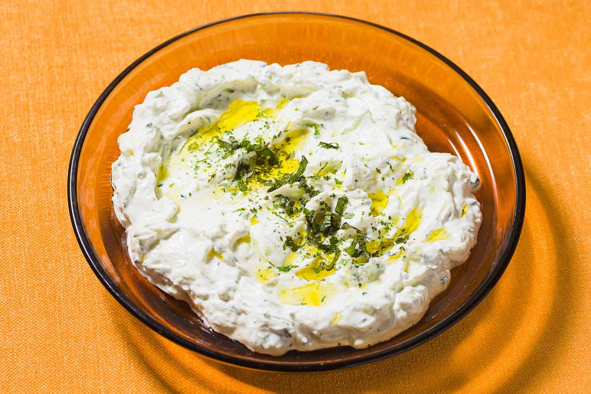 Maast O'Khiar garnished with dried mint and a drizzle of olive oil in a bowl.