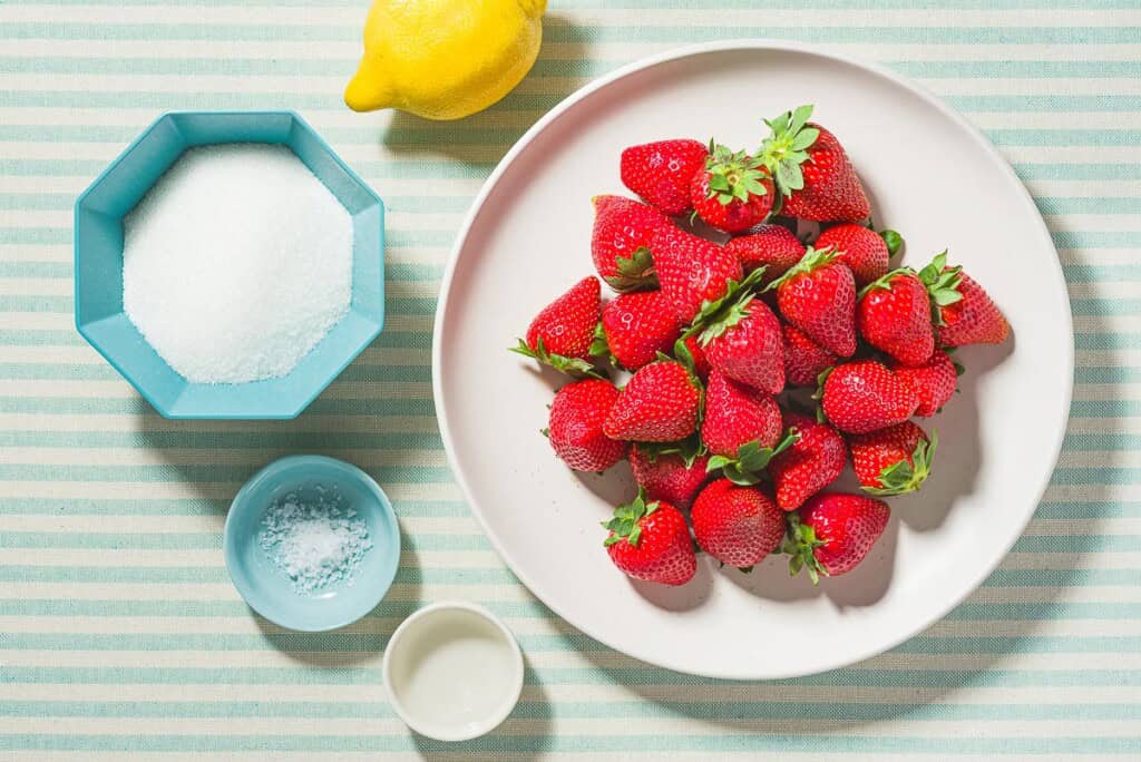 Ingredients for strawberry sorbet including strawberries, lemon, sugar, salt and rosewater.