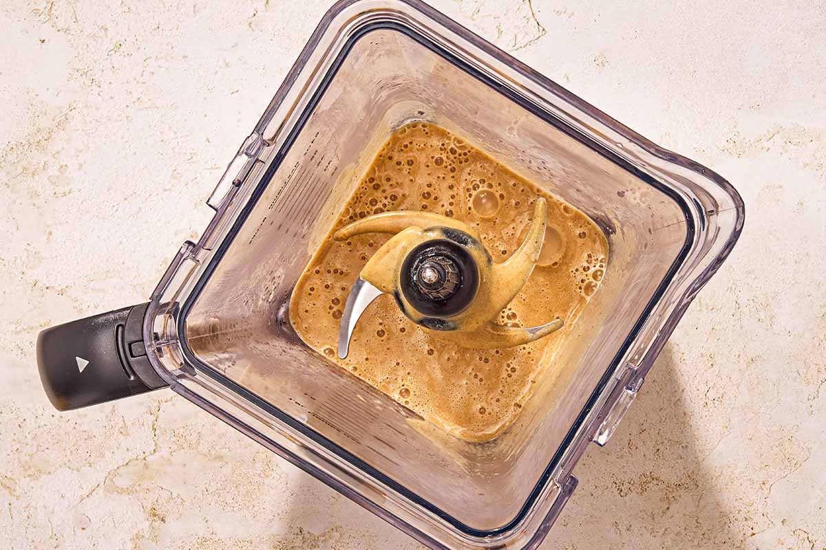 The milk mixture for the chia seed pudding in the pitcher of a blender.