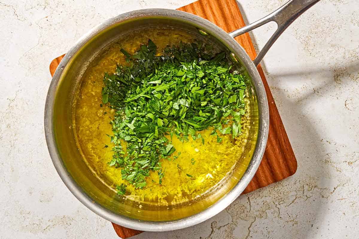 The garlic parmesan herb sauce for the chicken spiedini in a saucepan.
