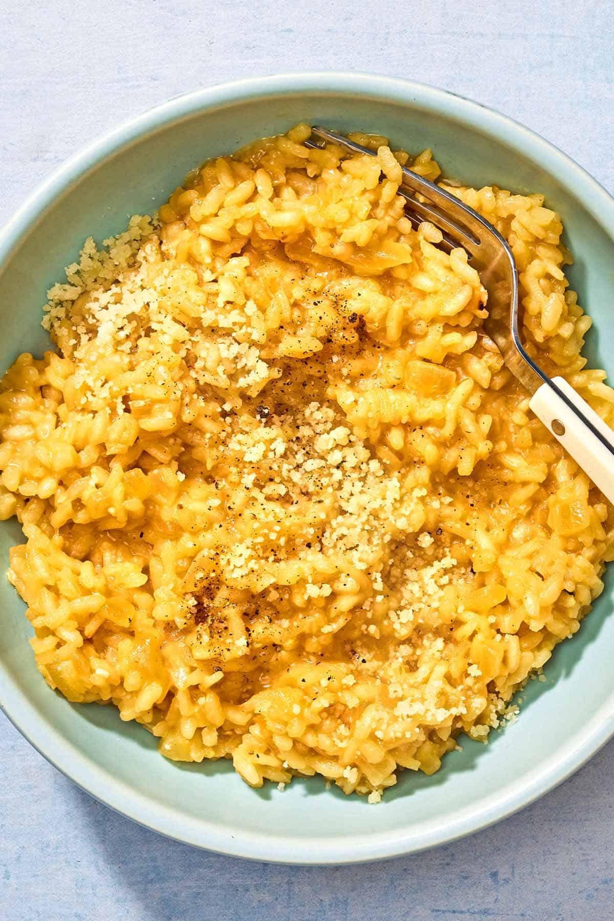 Risotto in a bowl with a fork.