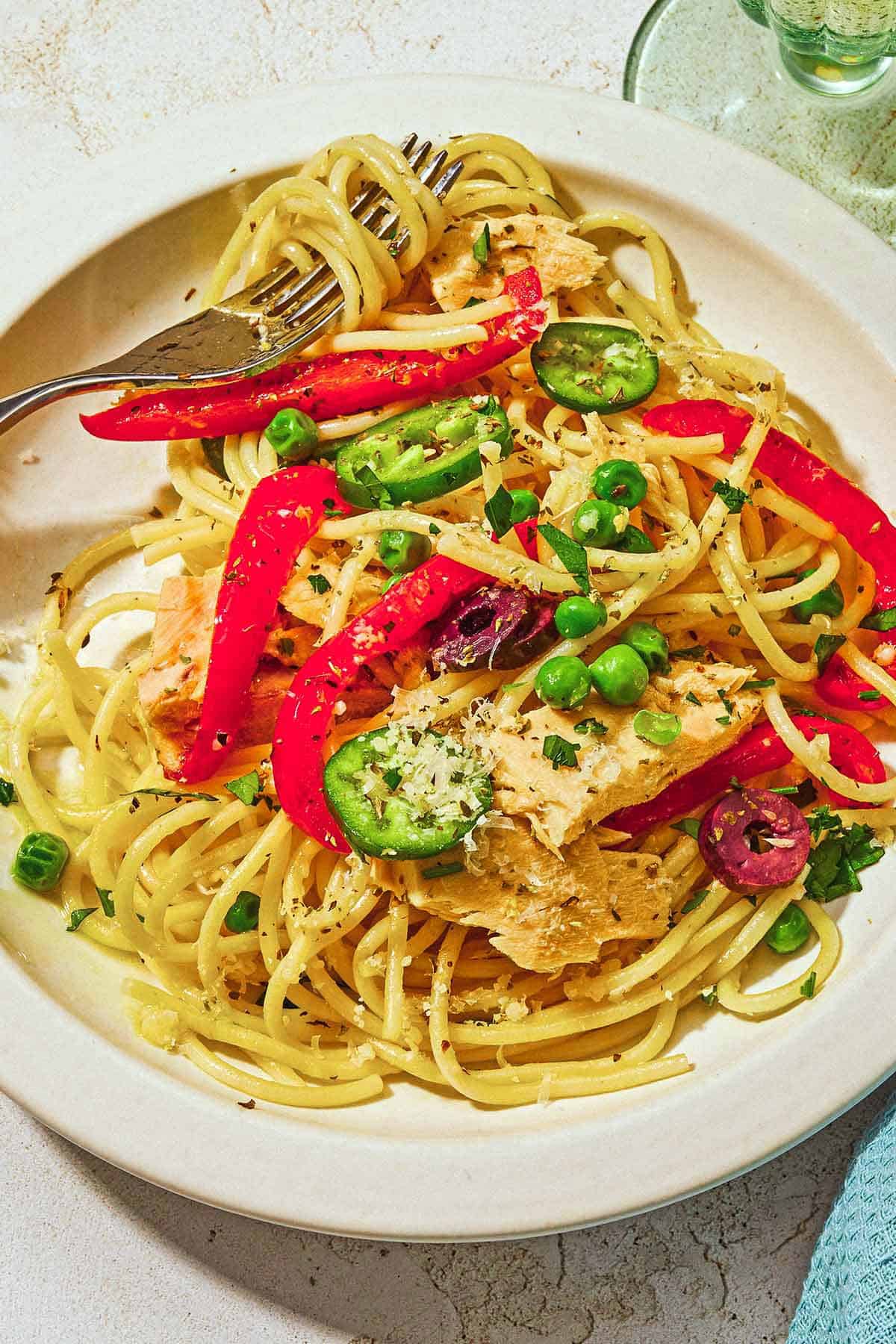 A serving of tuna pasta on a plate with a fork.