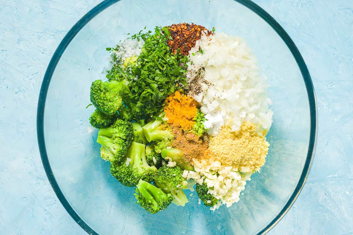 The ingredients for broccoli fritters in a bowl just before being mixed together.