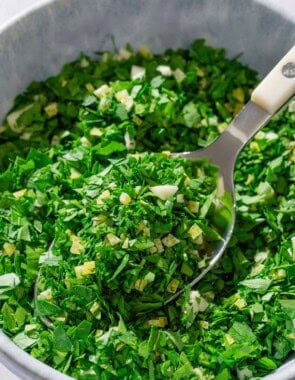 Gremolata in a bowl with a spoon.