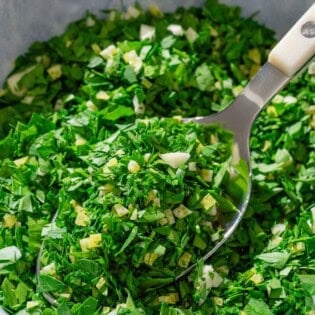 Gremolata in a bowl with a spoon.