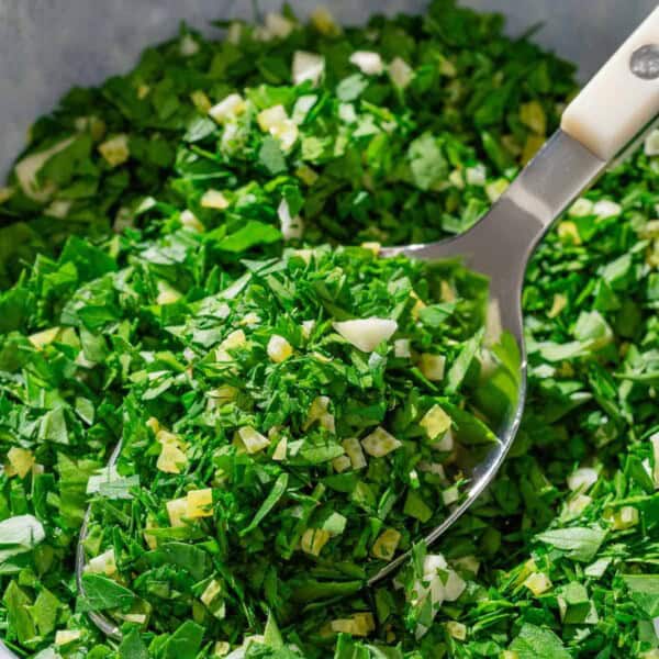 Gremolata in a bowl with a spoon.