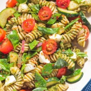 Pesto pasta salad on a platter.