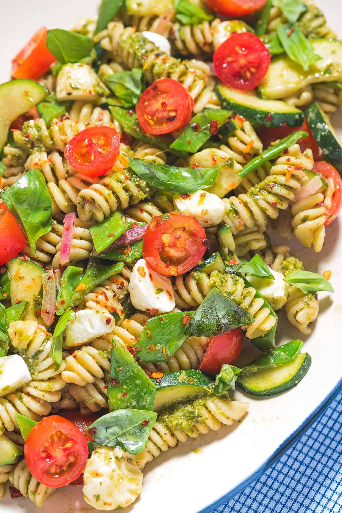 Pesto pasta salad on a platter.