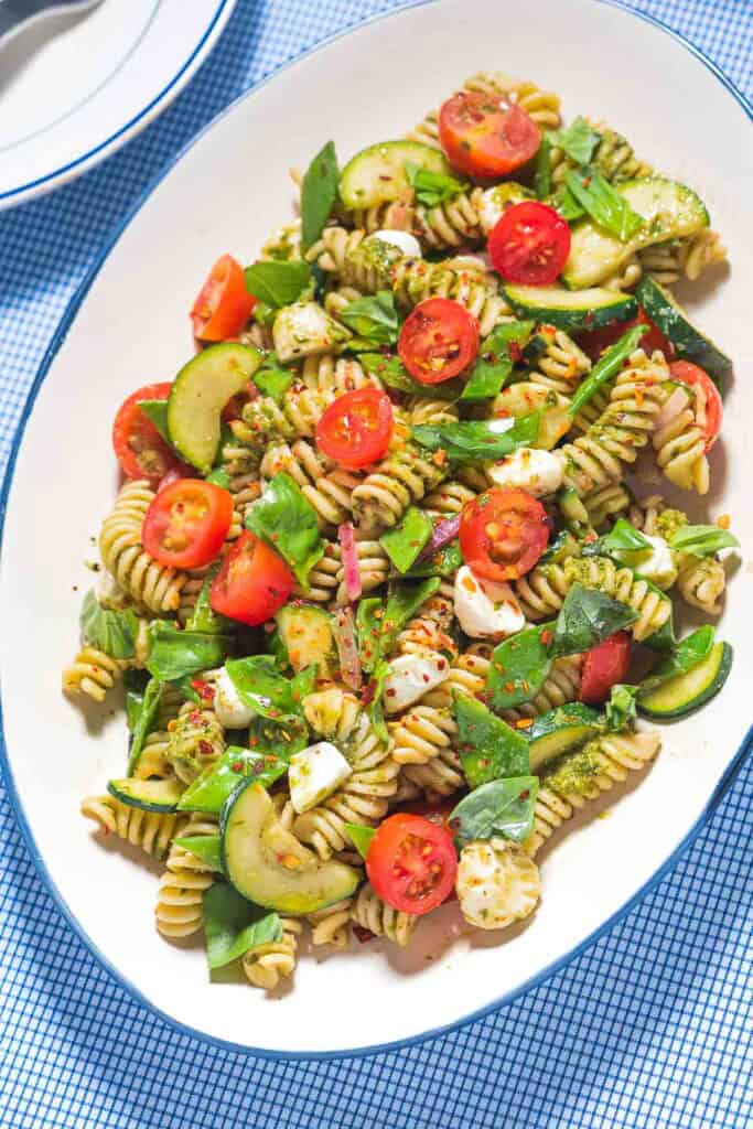 Pesto pasta salad on a platter.