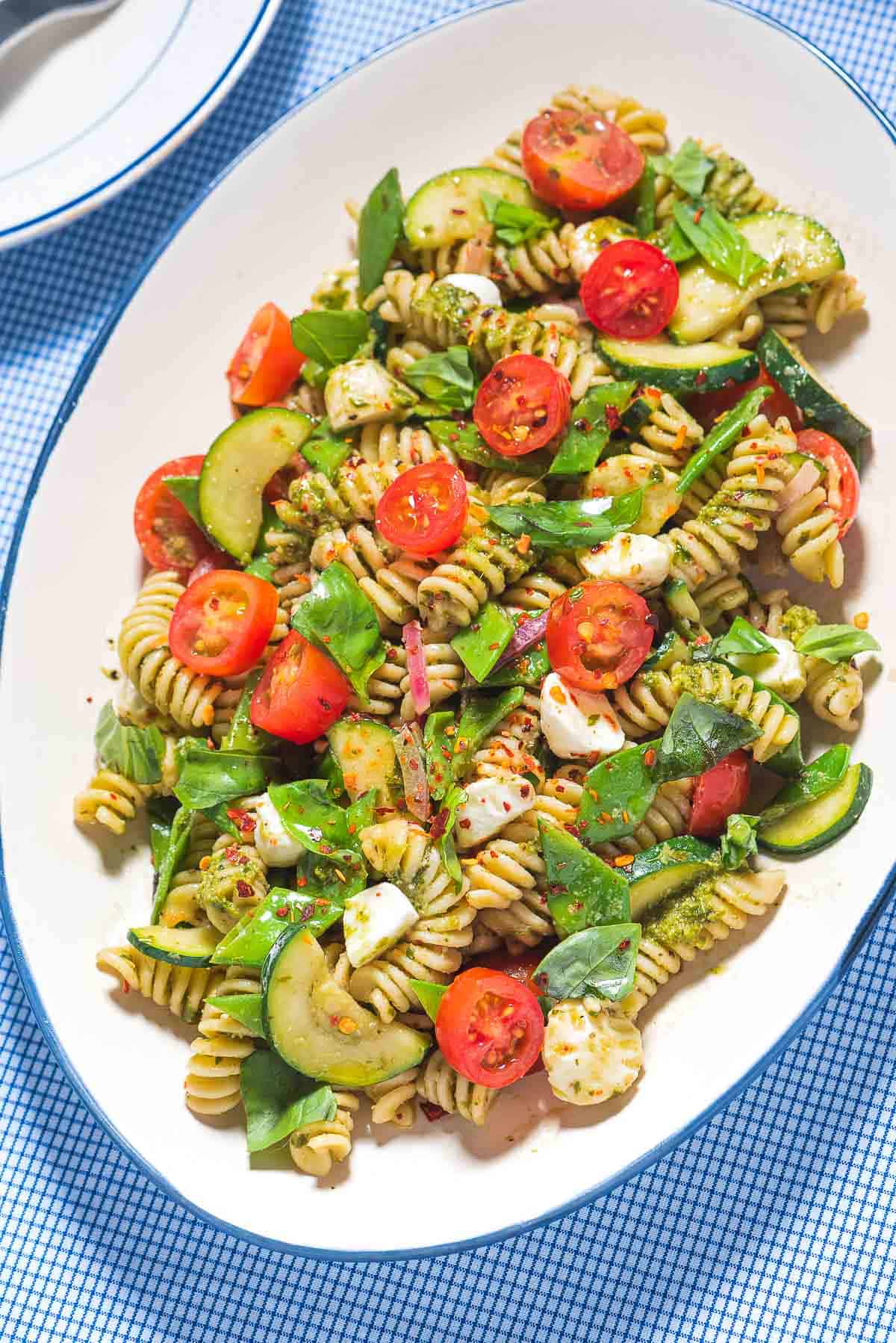 Pesto pasta salad on a platter.