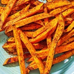 A close up of sweet potato fries on a platter.