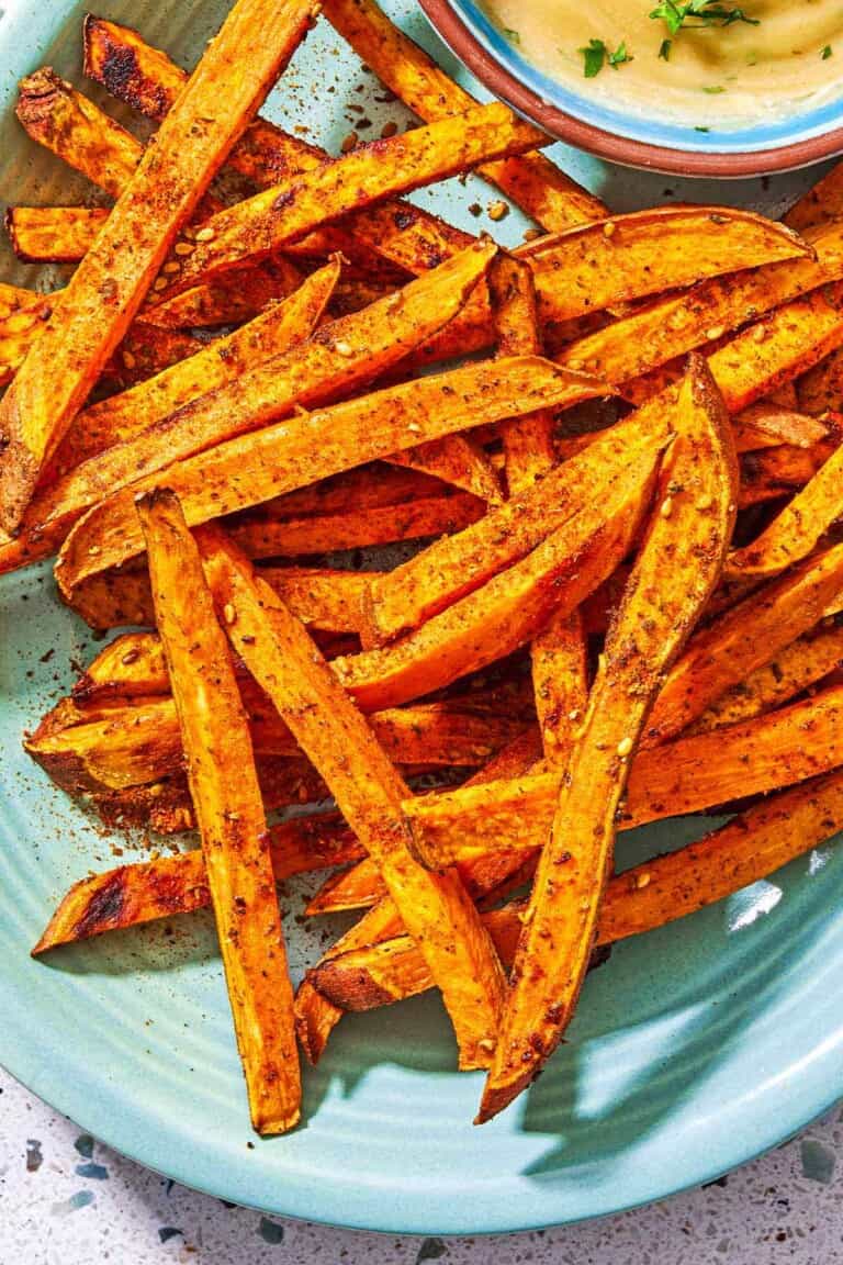 A close up of sweet potato fries on a platter.
