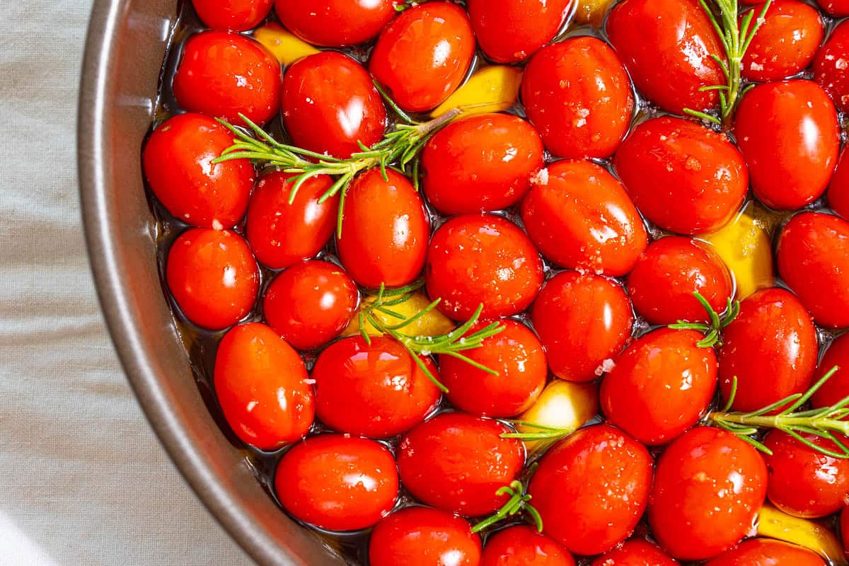 The ingredients for the tomato confit starting to cook in a saucepan.
