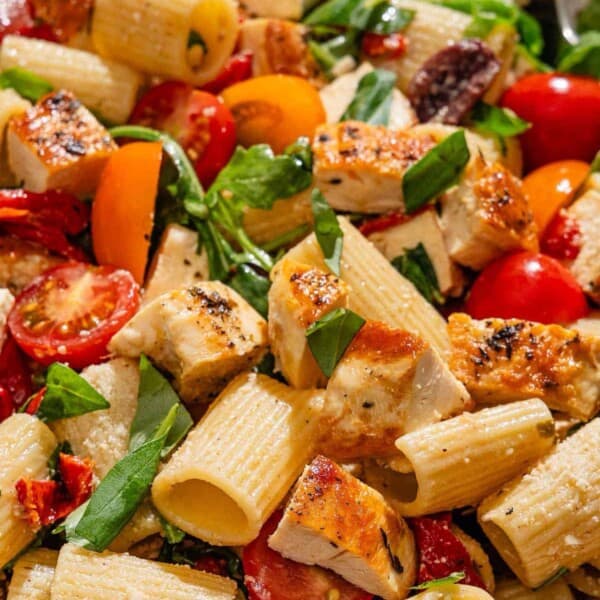 Chicken pasta salad in a serving bowl with a spoon.