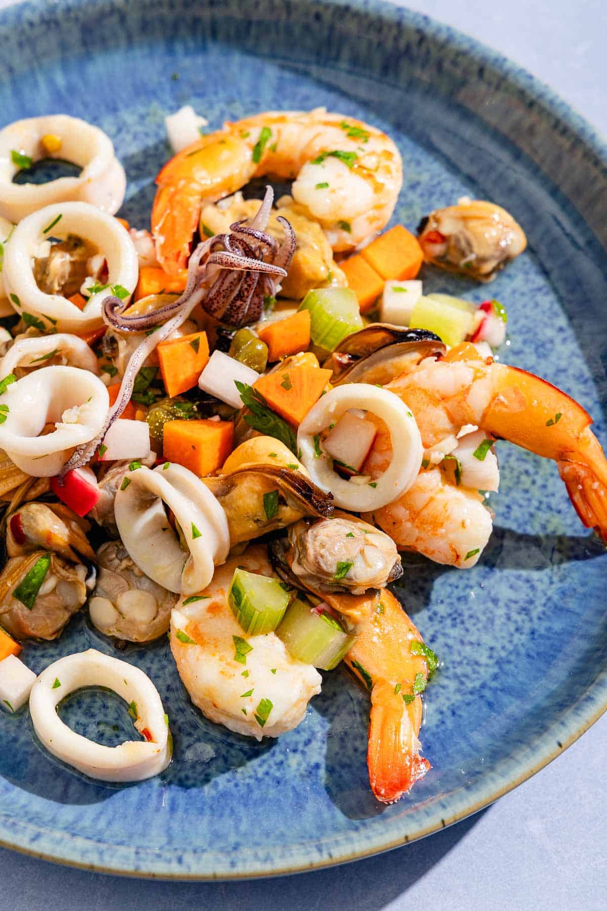 A serving of the seafood salad on a plate.